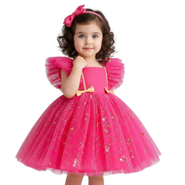 Young girl wearing a pink dress with gold accents on a white background